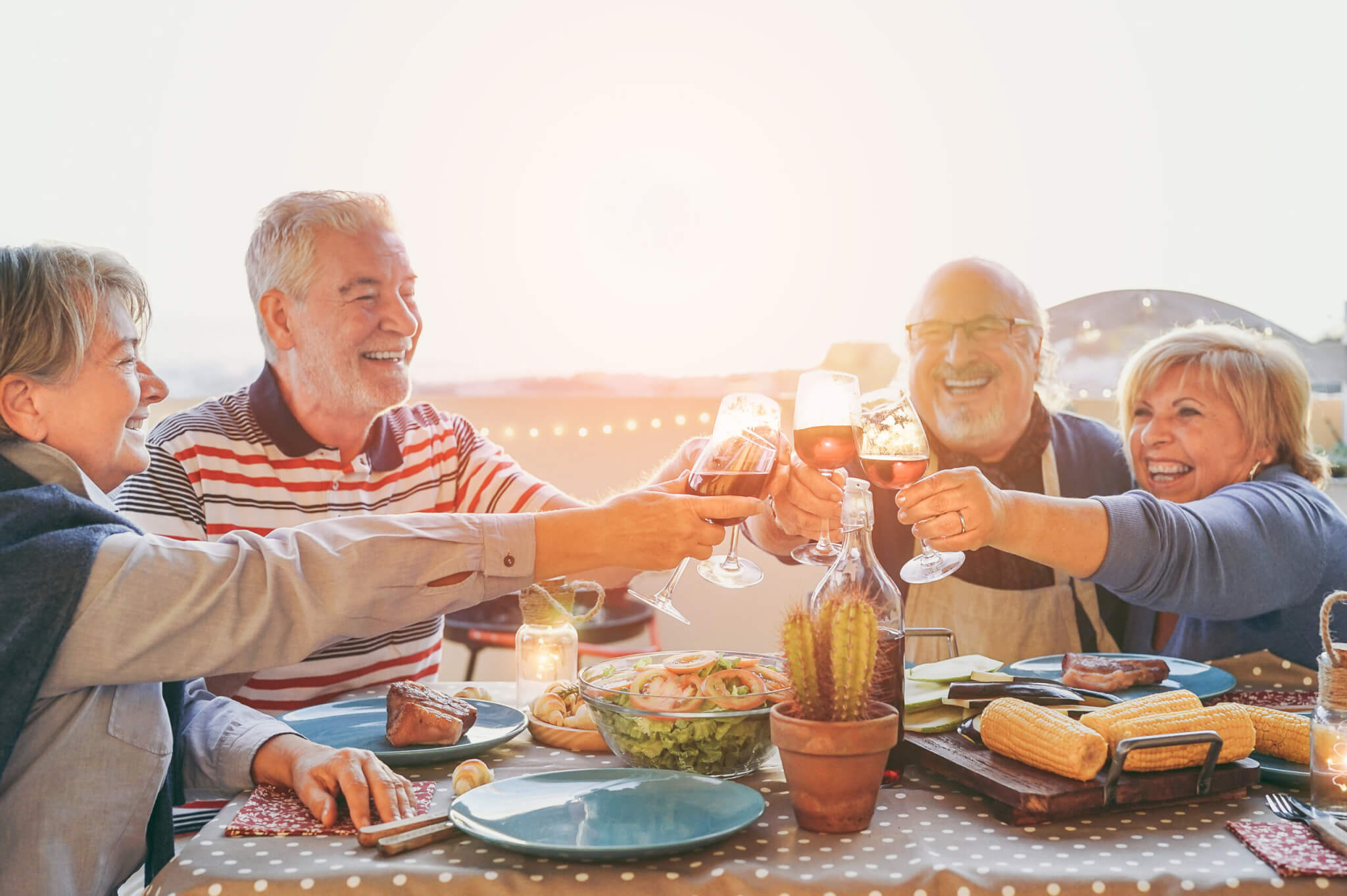 Happy,Senior,Friends,Having,Fun,Cheering,With,Red,Wine,At